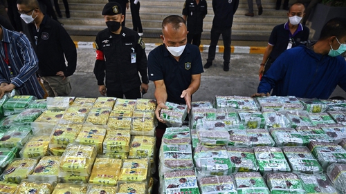 Thai policemen display packages of crystal meth before a press conference at the Narcotics Suppression Bureau in Bangkok