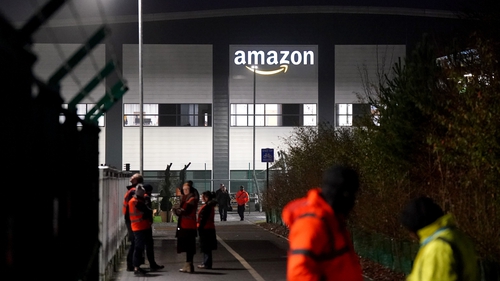 Amazon security staff keep an eye on members of the GMB union in Coventry, as Amazon workers stage their first ever strike in the UK in a row over pay