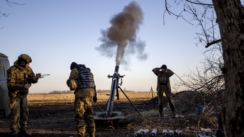 Ukrainian servicemen fire a mortar on the Donbass frontline