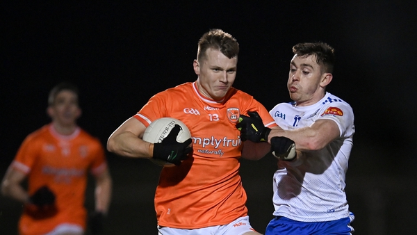 Armagh's Rian O'Neill fends off a tackle from Micheál Bannigan