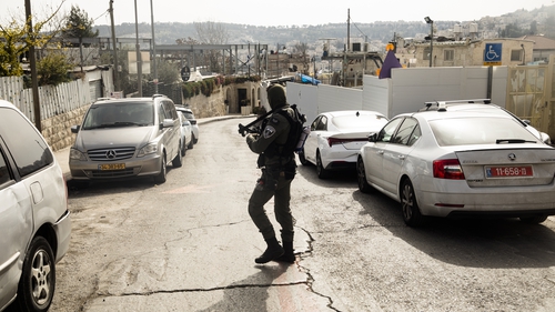 An Israeli police officer guards the scene where two Israelis were wounded in a shooting in East Jerusalem