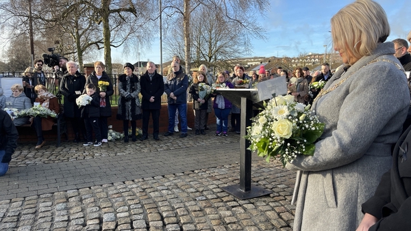 People gather at a memorial service for the victims of Bloody Sunday
