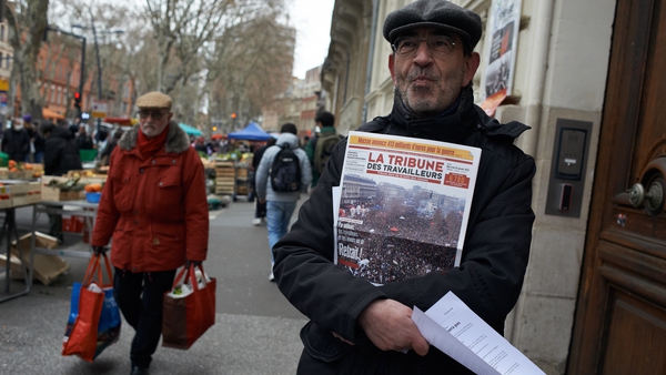 A man distributes leaflets and sells a newspaper against the Macron' pension reform in Toulouse, France