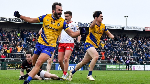 Roscommon's Donie Smith, left, celebrates his side's third goal, scored by teammate Ben O'Carroll, right