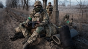 A Ukrainian paratrooper Andriy and comrades wait for transport along the road in Chasiv Yar, Donetsk region