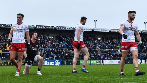 Tyrone players, from left, Michael McKernan, goalkeeper Niall Morgan, Brian Kennedy, and Padraig Hampsey, react after conceding a third goal to Roscommon