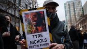 A man holds a sign at a protest in Oakland, California against the killing of Tyre Nichols