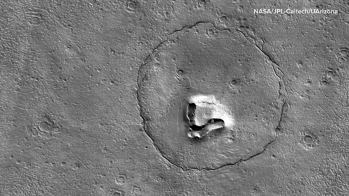 The latest image released from NASA's Mars Reconnaissance Orbiter shows hills, craters and a circular fracture pattern on the surface of Mars