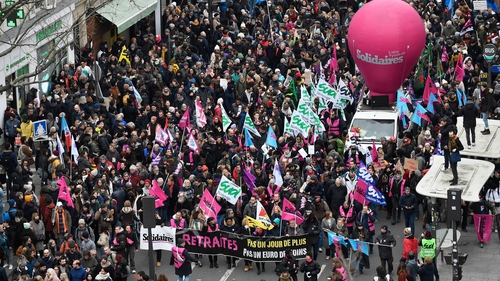 Huge crowds marching through Paris to denounce a reform that raises the retirement age by two years to 64
