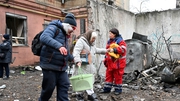 Residents taken from their home that was damaged in a Russian missile strike in Kharkiv