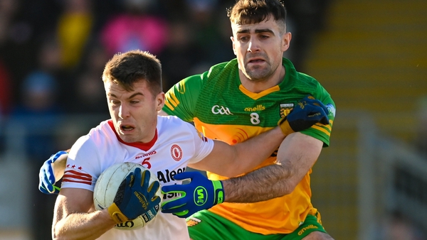 Tyrone's Cormac Quinn is tackled by Caolan McGonagle of Donegal