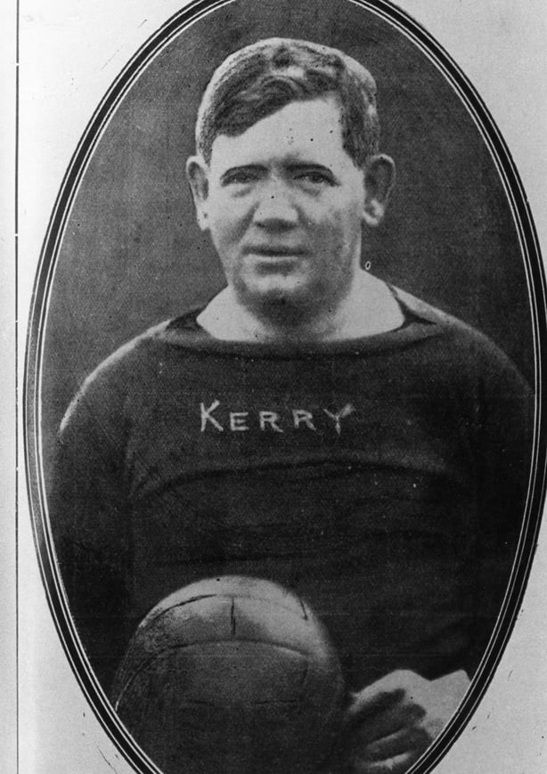 Black and white pic of Fitzgerald, a burly man in a football jersey, holding a ball