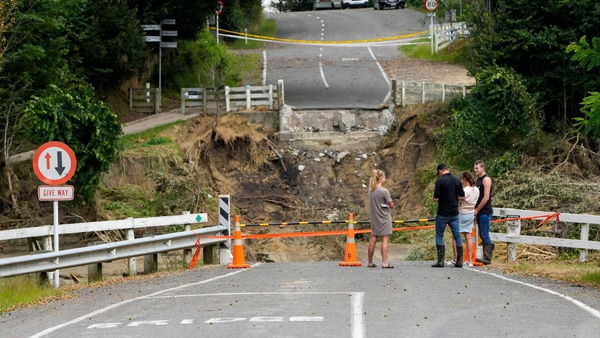 People look at the remains of the Puketapu Bridge that washed away during Cyclone Gabrielle near Napier