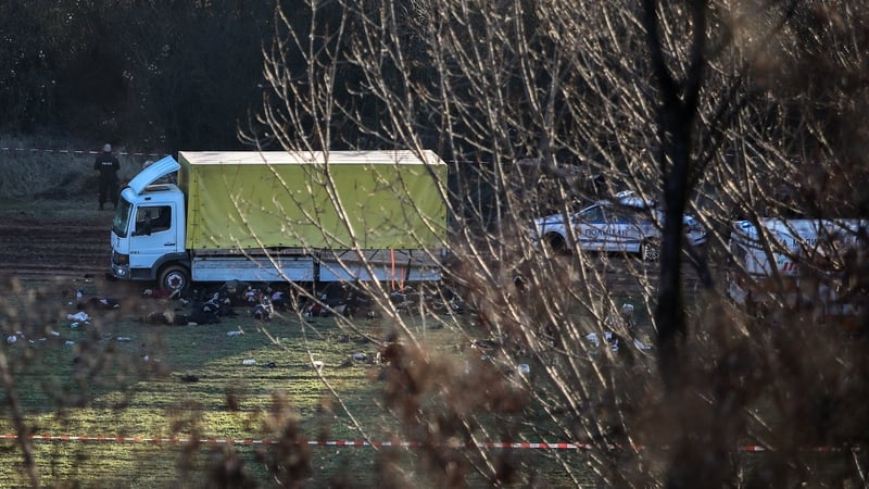 Police and emergency medical services on site after 18 people were found dead in an abandoned truck