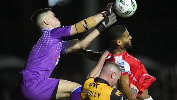 Noah Lewis of St Patrick's Athletic rises with Derry City goalkeeper Brian Maher
