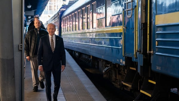 US President Joe Biden walks along the train platform after a surprise visit to Kyiv