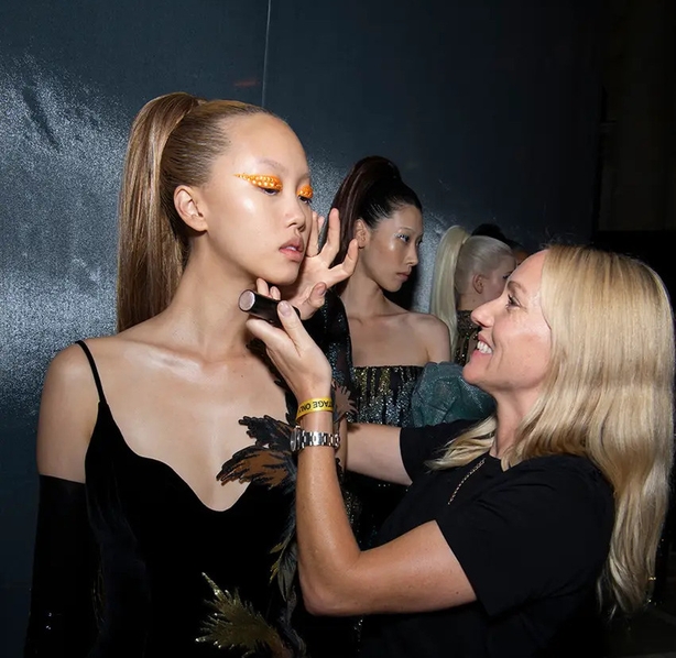 A NARS make-up artist works on a model backstage at Halpern SS23 (NARS/PA)