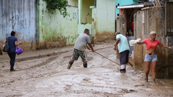 Locals begin the arduous task of cleaning up in Sao Sebastiao