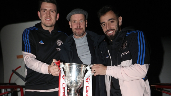 Harry Maguire, Erik ten Hag and Bruno Fernandes pose with the Carabao Cup after returning to Manchester on Sunday night