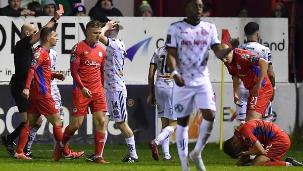 Players from both sides react as Dylan Connolly of Bohemians is shown a red card