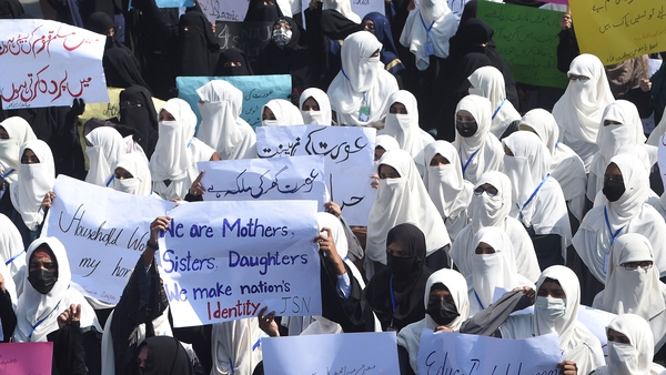 Religious Islamic party women hold placards as they march to mark International Women's Day in Lahore on 8 March 2022