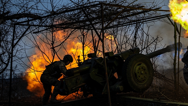 Ukrainian soldiers fire a D-30 Howitzer towards Russian infantry along the frontline outside of Soledar