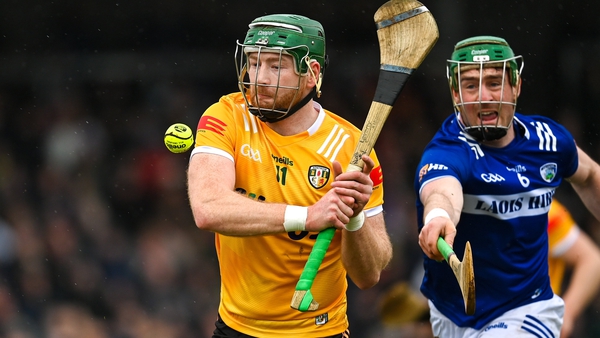 Antrim forward Niall McKenna in challenged by Patrick Purcell of Laois