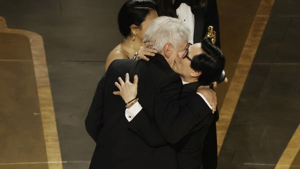 Ke Huy Quan (R) accepts the award for Best Picture for Everything Everywhere All at Once from Harrison Ford onstage during the 95th Annual Academy Awards at Dolby Theatre. (Photo by Kevin Winter/Getty Images)