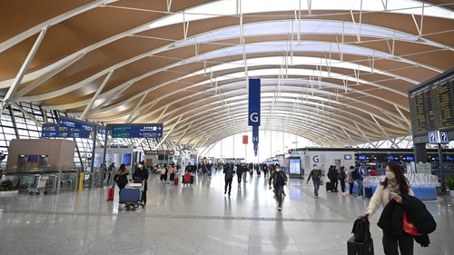 Passengers move through Shanghai Pudong International Airport