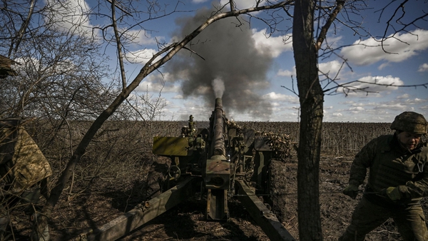 Ukrainian servicemen fire at Russian positions with a 105mm howitzer in the Donbas region