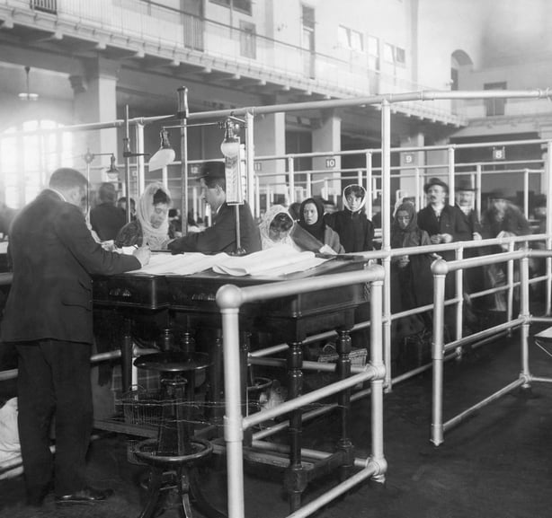 Immigrants going through maze to have their papers checked. Photograph at Ellis Island, 1920's.