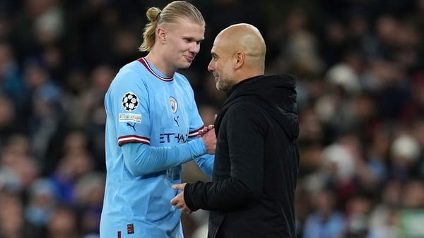 Pep Guardiola (R) embraces Erling Haaland after the Manchester City striker was substituted against RB Leipzig
