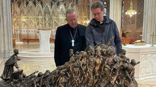 Eamon Martin and Fr Bill Kemmy at the sculpture in Armagh Cathedral