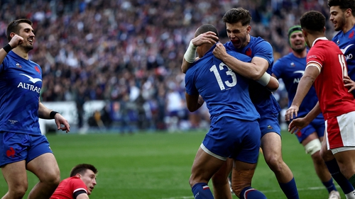 Gael Fickou (13) is congratulated after scoring France's fourth try