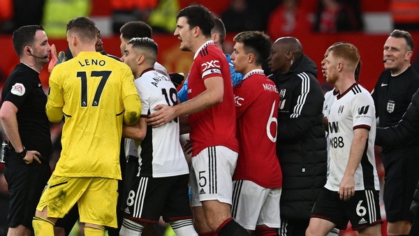 The referee is surrounded after sending off Mitrovic