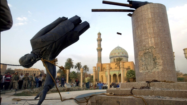 US troops topple a statue of Saddam Hussein on 9 April 2003 in Baghdad, Iraq