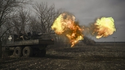 Ukrainian servicemen fire with a S60 anti-aircraft gun at Russian positions near Bakhmut