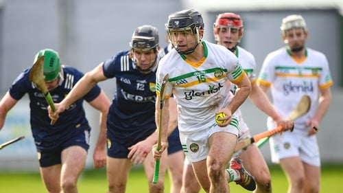 David Nally of Offaly wheels away from two Kerrymen