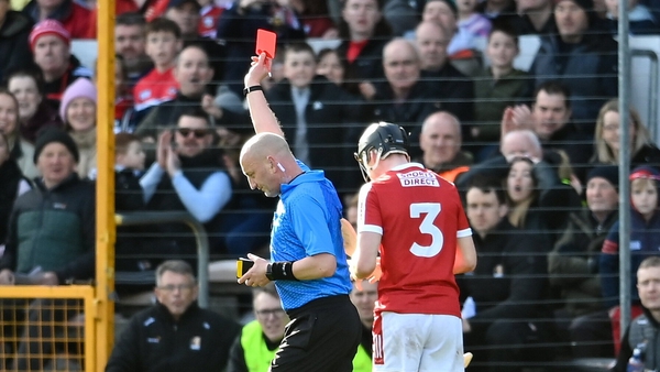 Referee John Keenan shows a red card to Eoin Downey