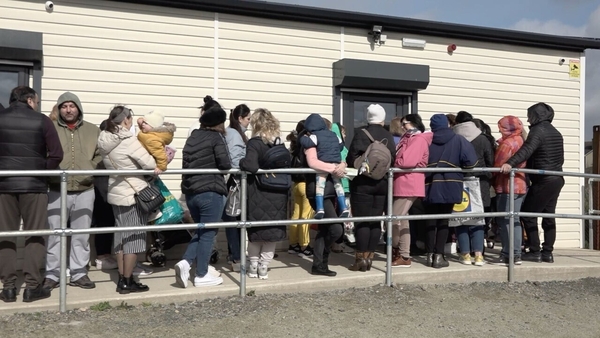 People queue outside the free shop every Tuesday morning before it opens at 11am