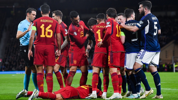 Spain's Pedro Porro lies on the ground in one of many stoppages in play at Hampden Park