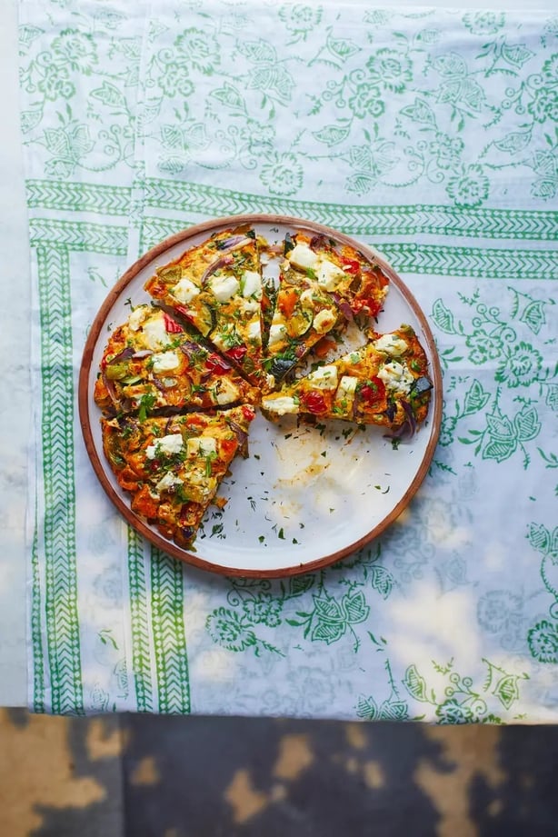 1. Preheat oven to 200°C/gas 6. Put the sweet potato, peppers, onion and courgette in a roasting tin and drizzle over half the oil. Season with salt and pepper, then cover with foil and bake for 20 minutes. Remove the foil and check the vegetables are tender, then continue to cook, uncovered, for a further 10 minutes.  2. Meanwhile, heat the remaining oil and butter in a large non-stick frying pan or well-seasoned skillet. Add the chilli and garlic and sauté for two to three minutes, just to take away the harsh raw flavour from the garlic. Stir in the turmeric.  3. Add the roast vegetables, the herbs and the peas, and stir to coat in the oil. Season the eggs with salt and pepper, then pour this around the vegetables. Top with the cheese.  4. Preheat your grill to medium-high. Cook the frittata over a high heat until you can see the underside has set and browned, then transfer to the grill and continue to cook until the eggs are set and have puffed up slightly. The cheese will be soft and creamy.  5. Leave to stand for a few minutes, then carefully cut into wedges. Good hot or cold.  4 Steps To A Healthier, Happier You by Tess Daly is published by Bantam, priced £18.99. Available now.
