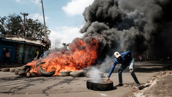 Protesters set mounds of tires alight to block off streets in Kibera, Nairobi's largest slum
