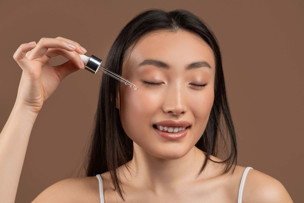 Woman applying retinol