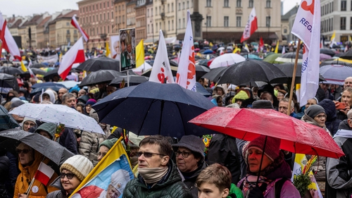 Supporters attend a march to defend the memory of Pope John Paul II in Warsaw