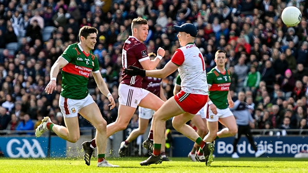 Johnny Heaney shoots at goal under pressure from Mayo goalkeeper Colm Reape and Conor Loftus
