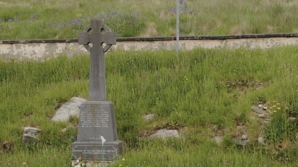 Stone cross memorial in a field