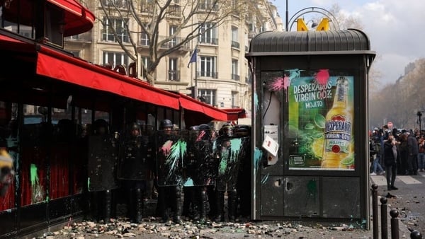 Riot police shield themselves from projectiles at 'La Rotonde' brasserie in Paris