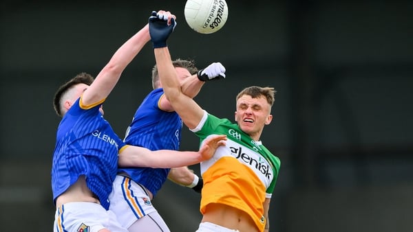 Jack McEvoy of Offaly in action against Michael Quinn and Jack Macken of Longford