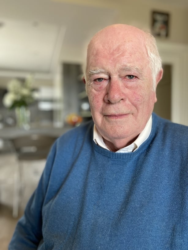 Paudie Fuller, a white haired white man wearing a blue jumper